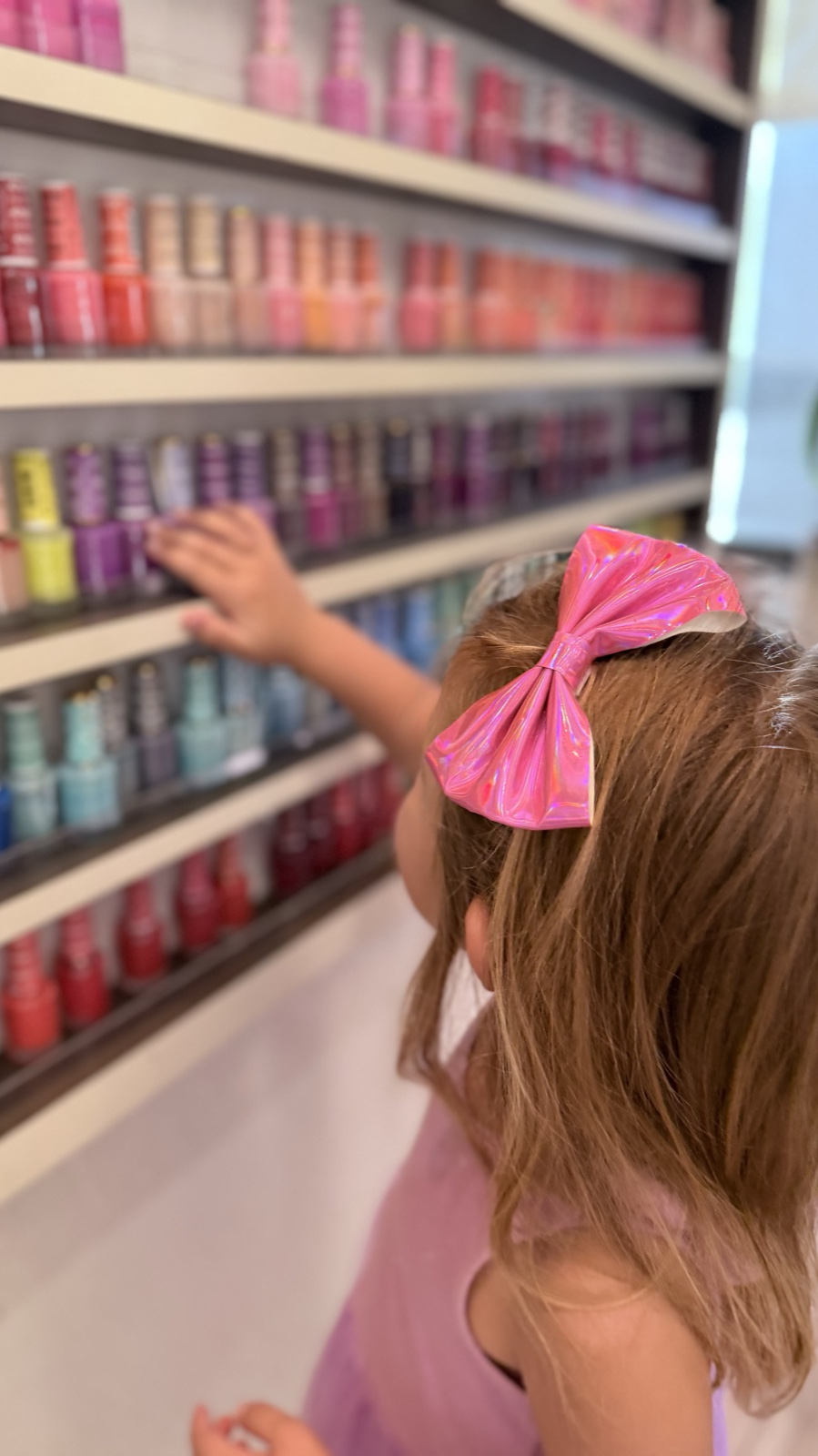 Child selecting polish for a manicure